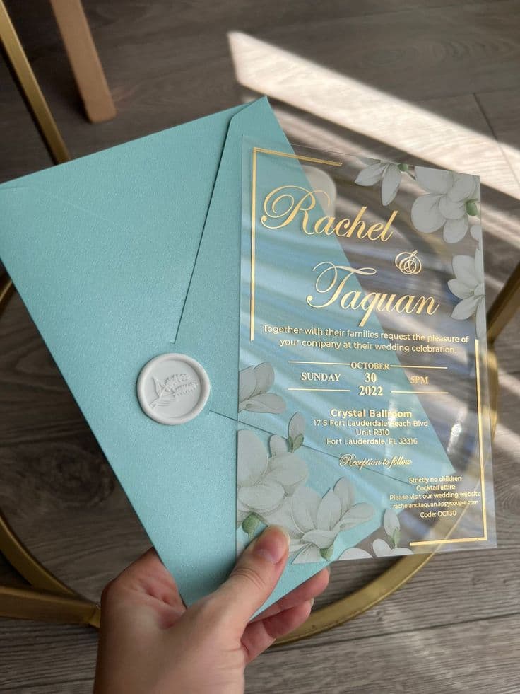 Transparent acrylic wedding invitation with gold foil lettering